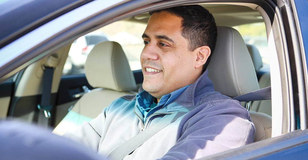 man smiling sitting in vehicle driver seat
