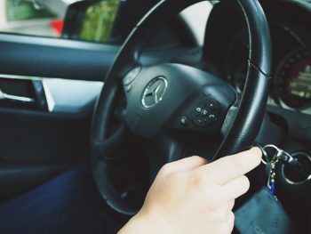 photo of hands holding a car steering wheel